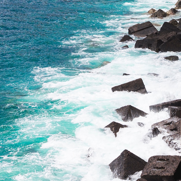 Close-up wavy water at rocky seashore