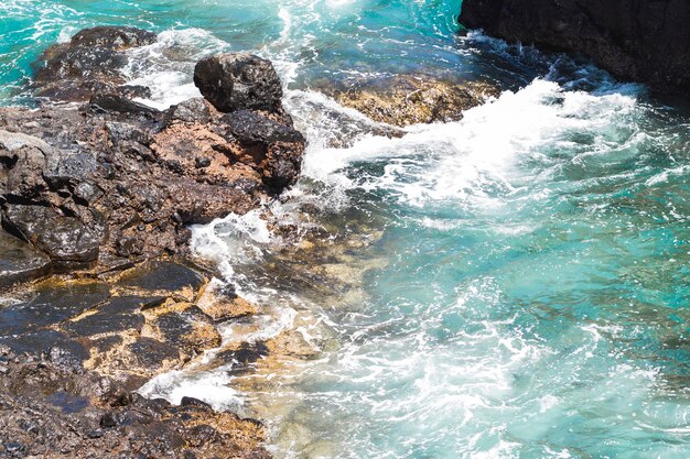 Close-up  wavy water at rocky shore