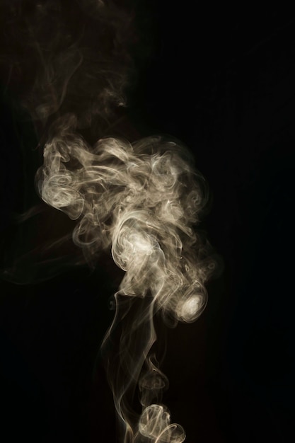 Close-up of wavy white smoke effect on black background