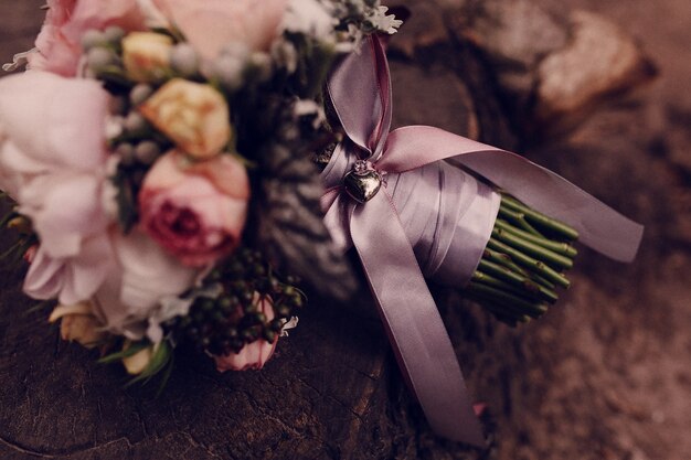 Close-up of wedding bouquet with purple bow