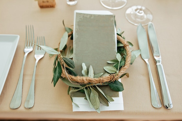 Close up of wedding table setting decorated with eucalyptus flower wreath