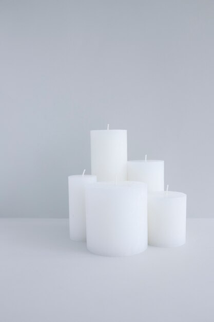 Close-up of white candles against grey background