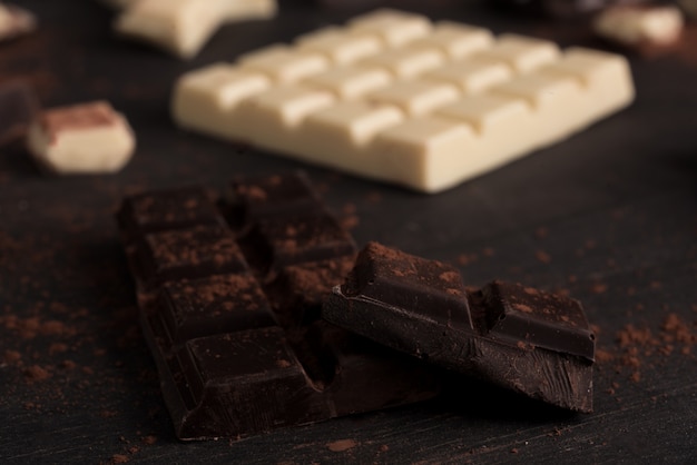 Close-up of white and dark chocolate bars covered in powder