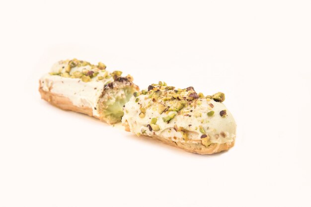 Close up of white eclair with nuts