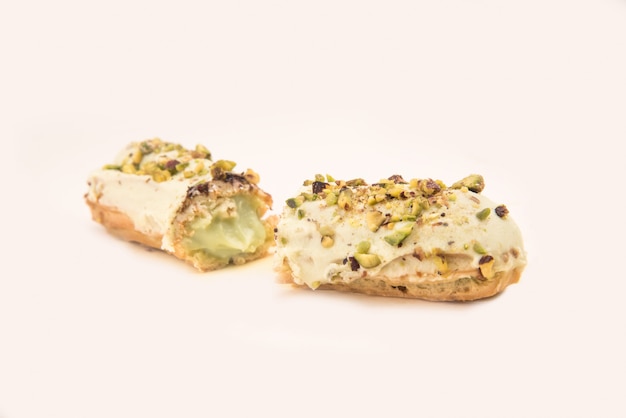 Close up of white eclair with nuts