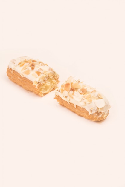 Close up of white eclair with nuts