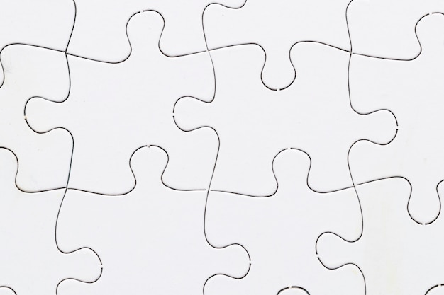 Free photo close-up of white jigsaw puzzle grid background