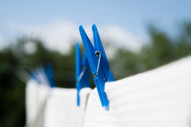 Close-up white laundry hanging on a string outdoors