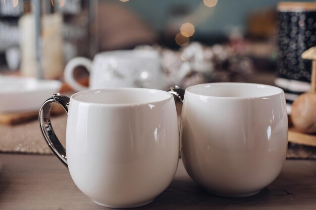 Close up of white mugs of hot drinks. Copy space. New Year eve concept