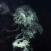 Free photo close-up of white smoke spread over a black background