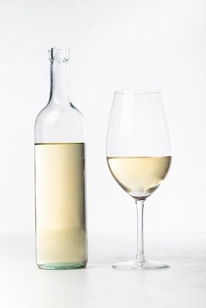 Close-up white wine glass and bottle