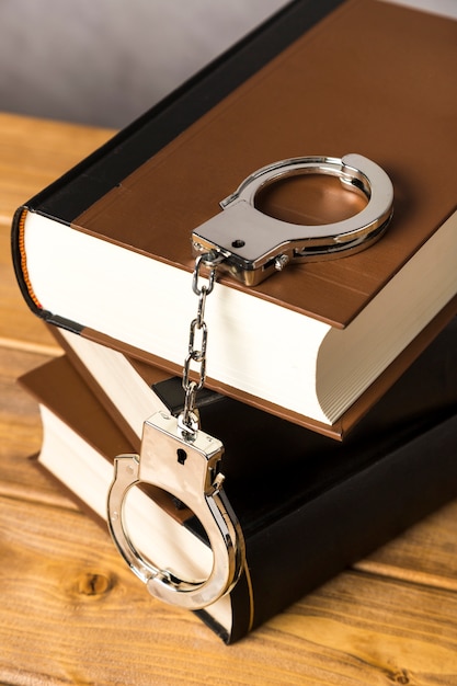 Close-up with handcuffs on books