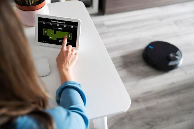 Close up woman activating robot cleaner