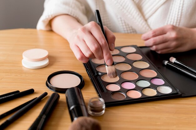 Close-up woman applying eye shadow