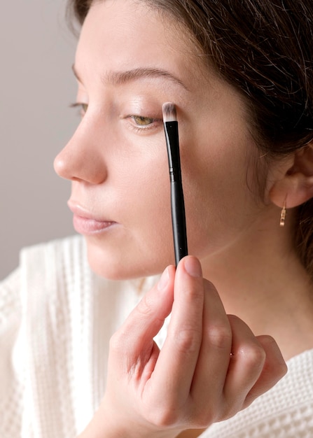 Close-up woman applying eyeshadow