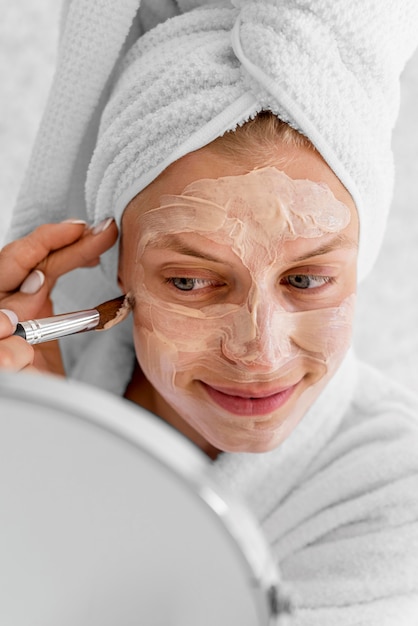 Close-up woman applying homemade remedy