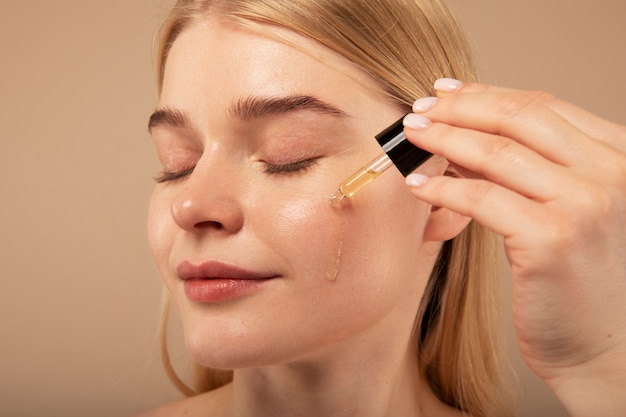 Close up woman applying serum