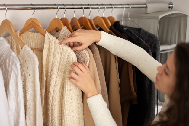 Close up woman arranging wardrobe
