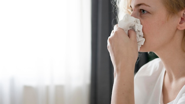 Free photo close-up woman blowing her nose