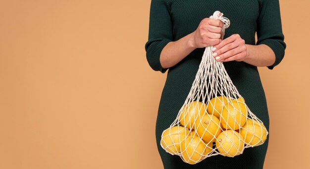 Close up woman in casual clothes carrying reusable turtle bag