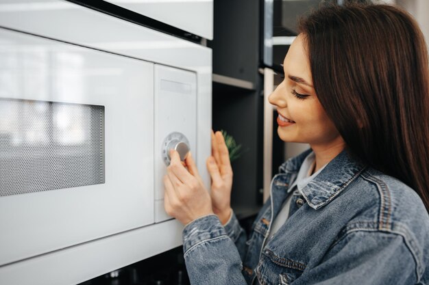 Close up of a woman checking new microwave oven in hypermarket