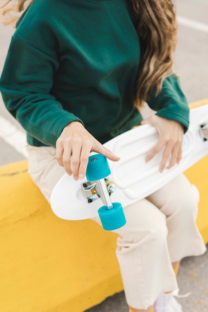 Close-up woman checking skateboard wheels