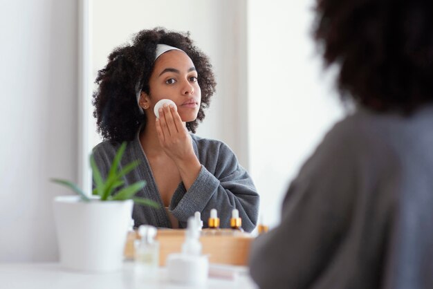 Close up woman cleaning face