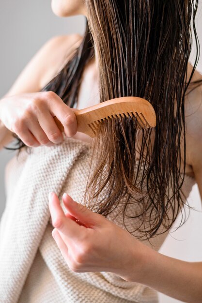 Close-up woman combing hair