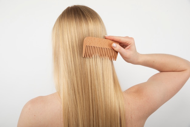 Close up woman combing her hair