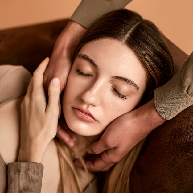 Free photo close-up of woman on the couch with man holding her head