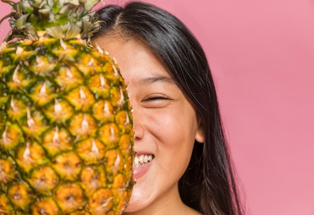 Close-up of woman covering her face and smile