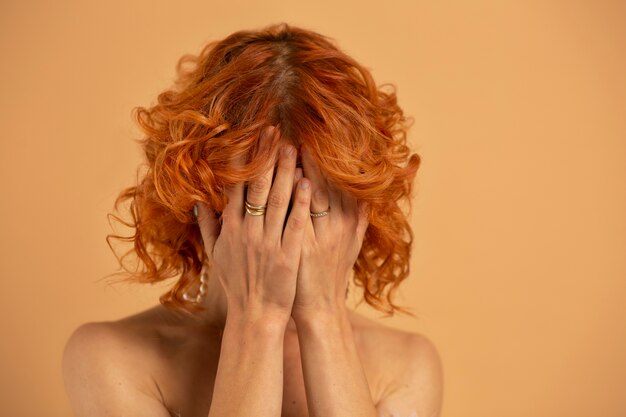 Close up woman covering her face