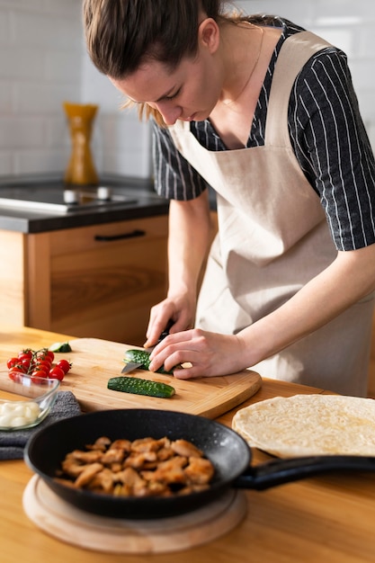 Close up woman cutting cucumber