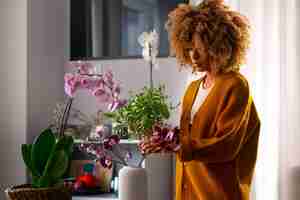 Free photo close up on woman decorating her home with orchids