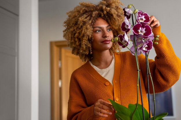 Close up on woman decorating her home with orchids