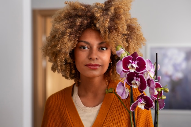 Close up on woman decorating her home with orchids