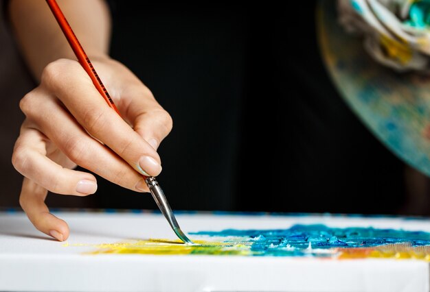 Крупным планом женщина, рисование масляными красками на холсте