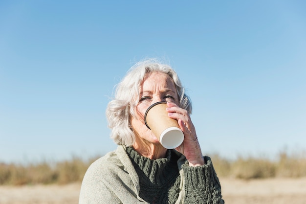 Close-up woman drinking coffee