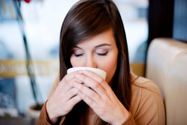 Close up of woman drinking coffee