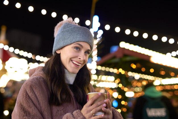 Close up of woman drinking mulled wine on cold night