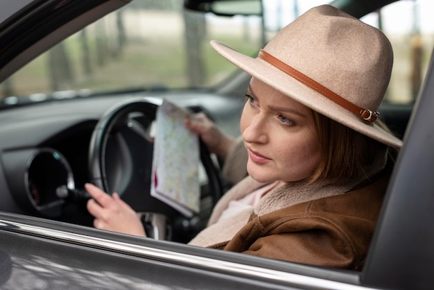 Close up woman driving with map