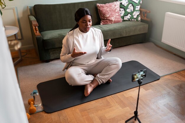 Close up on woman exercising after online instructor