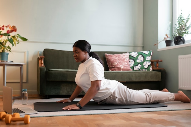 Close up on woman exercising after online instructor