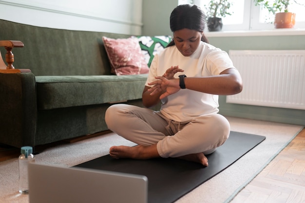 Close up on woman exercising after online instructor