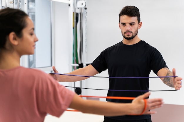 Free photo close up woman exercising with band