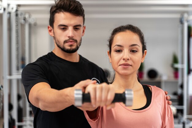 Close up woman exercising with dumbbell