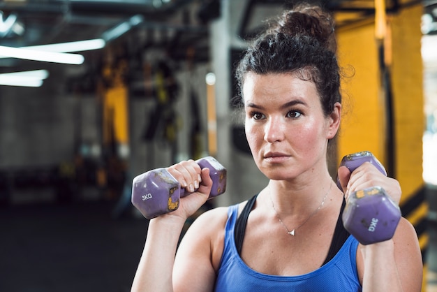 Close-up of a woman exercising with dumbbells