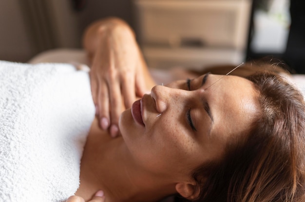 Close-up woman experiencing acupuncture