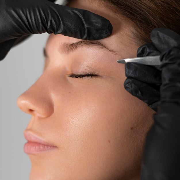 close-up of woman getting her eyebrows done