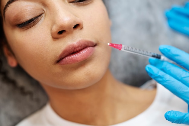 Close up woman getting hyaluronic acid injection